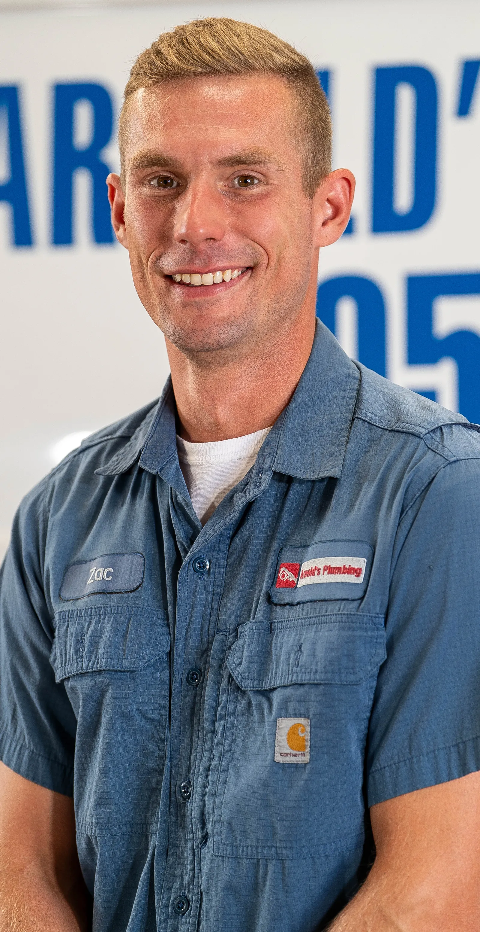 An Arnold's team member photographed in front of the company van