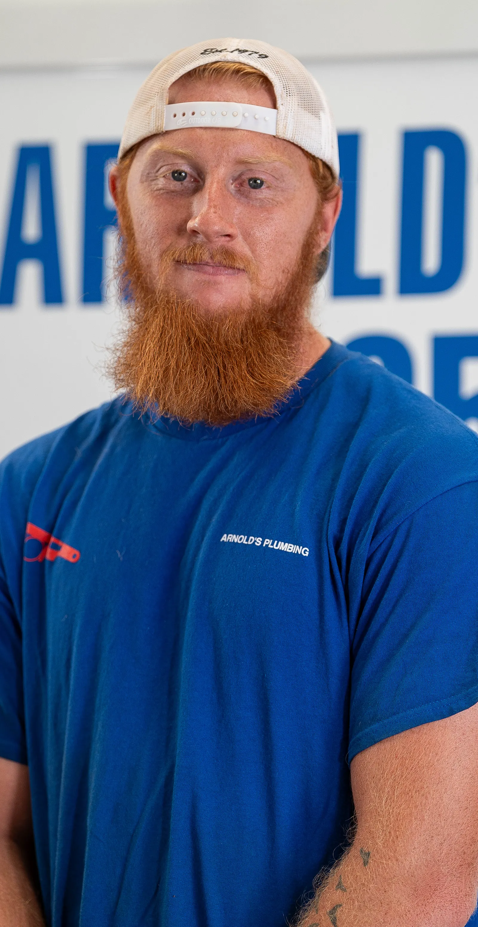 An Arnold's team member photographed in front of the company van