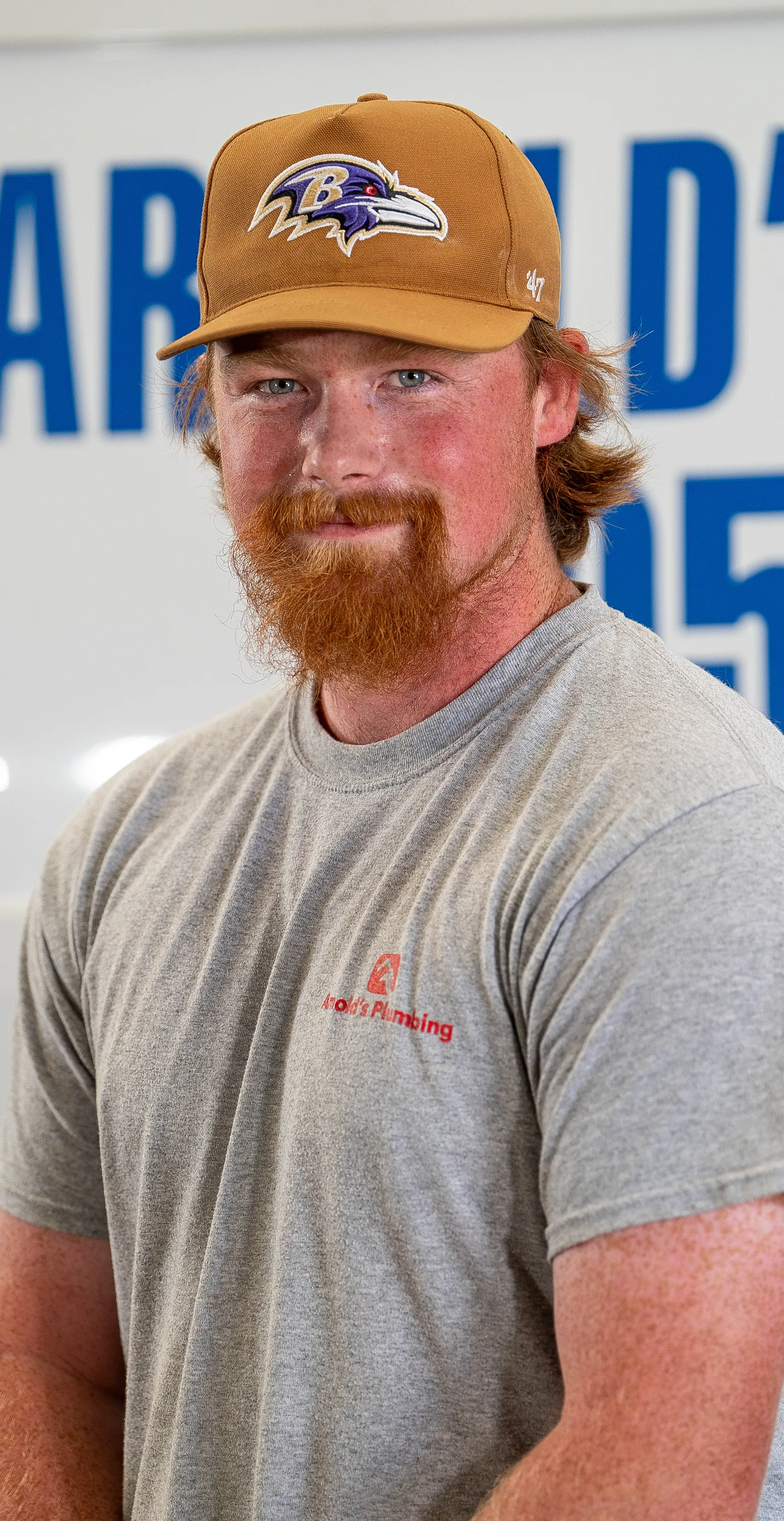 An Arnold's team member photographed in front of the company van