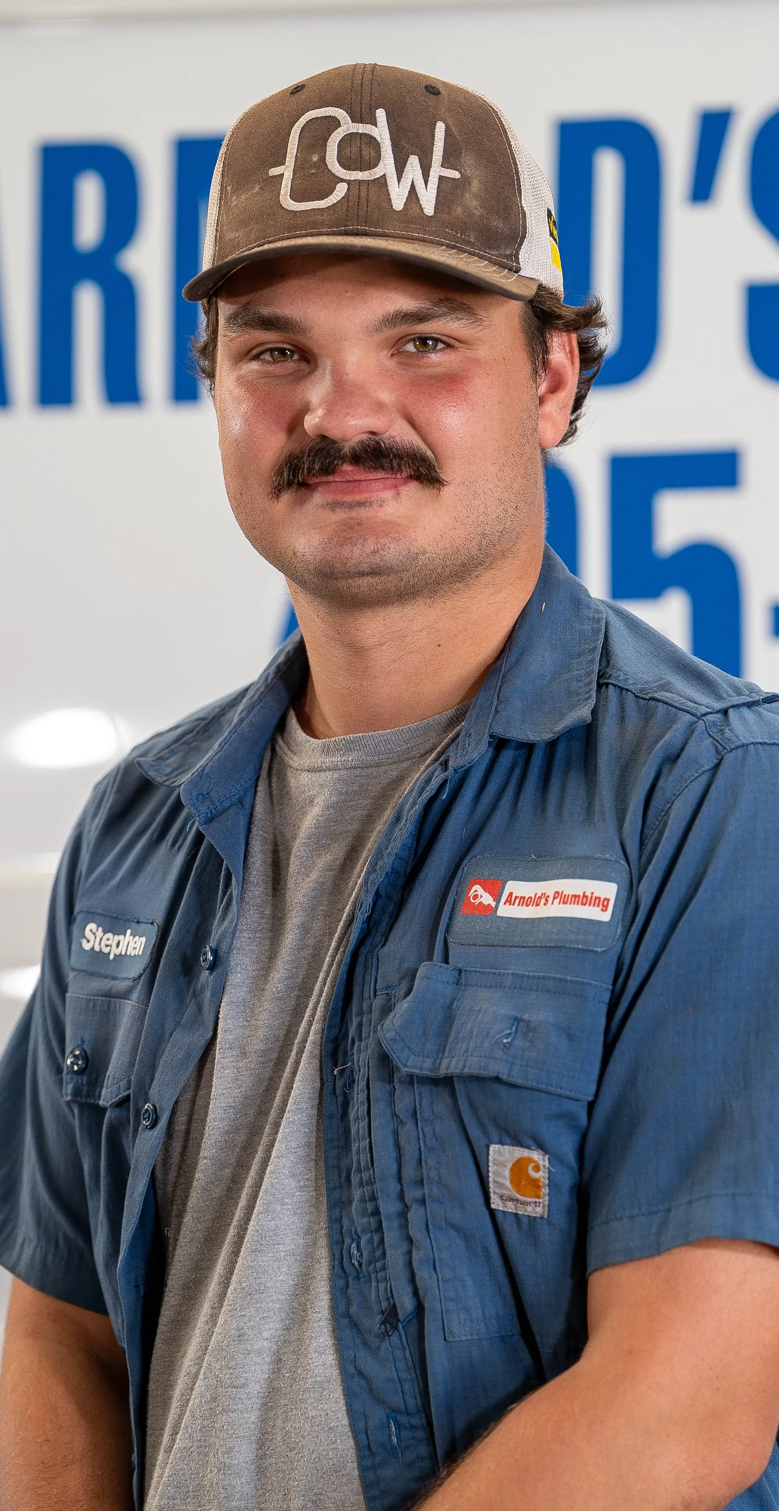 An Arnold's team member photographed in front of the company van