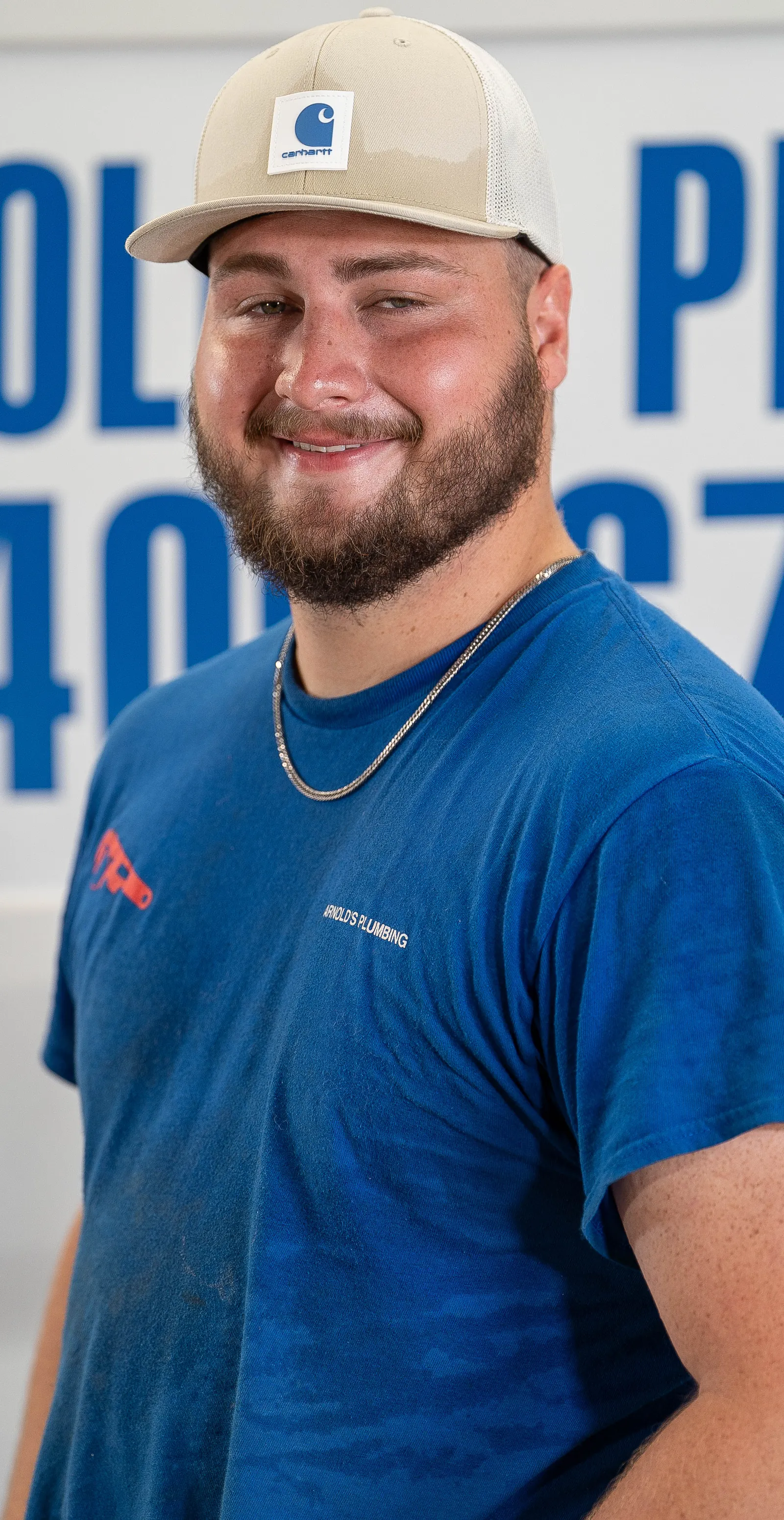 An Arnold's team member photographed in front of the company van