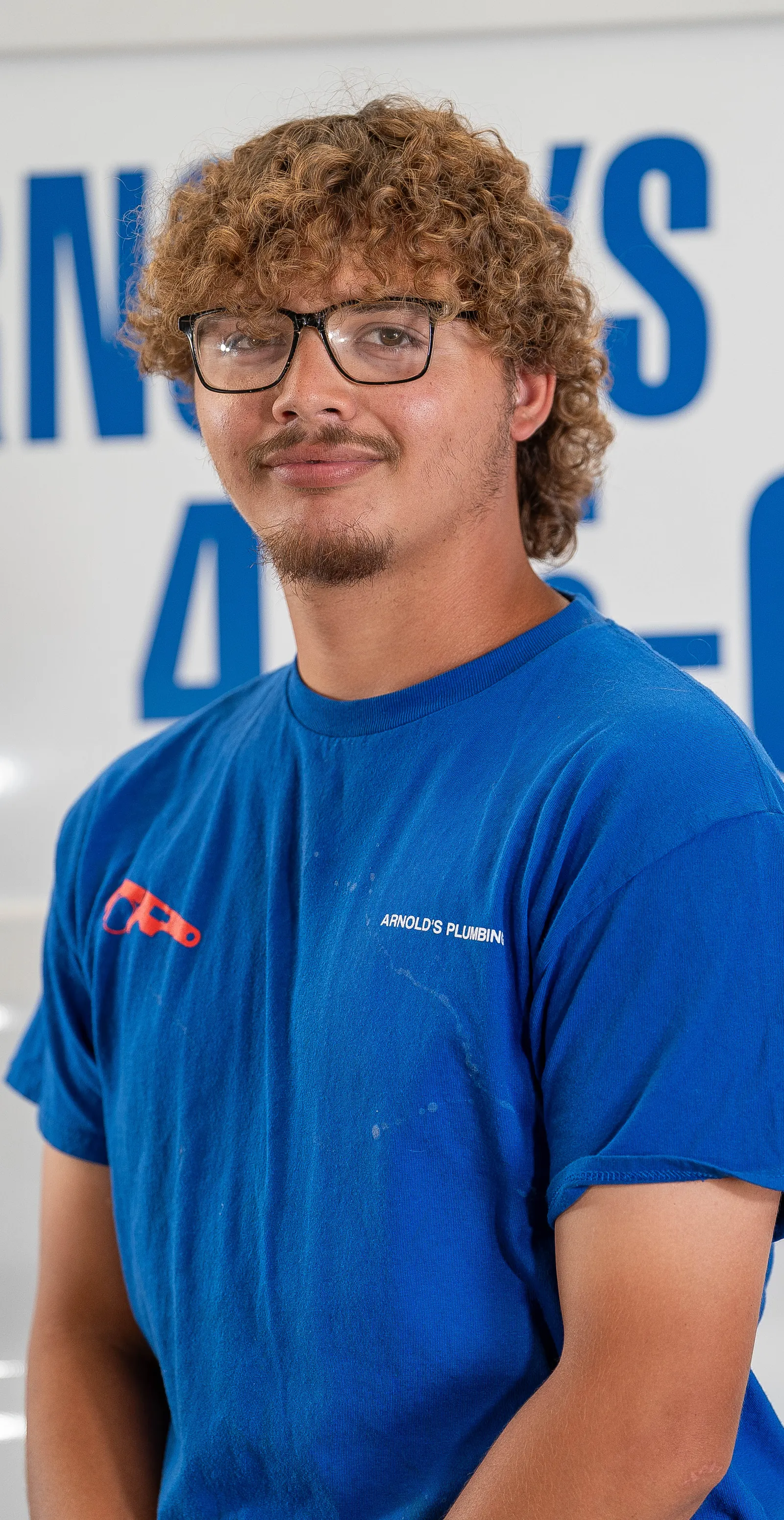 An Arnold's team member photographed in front of the company van