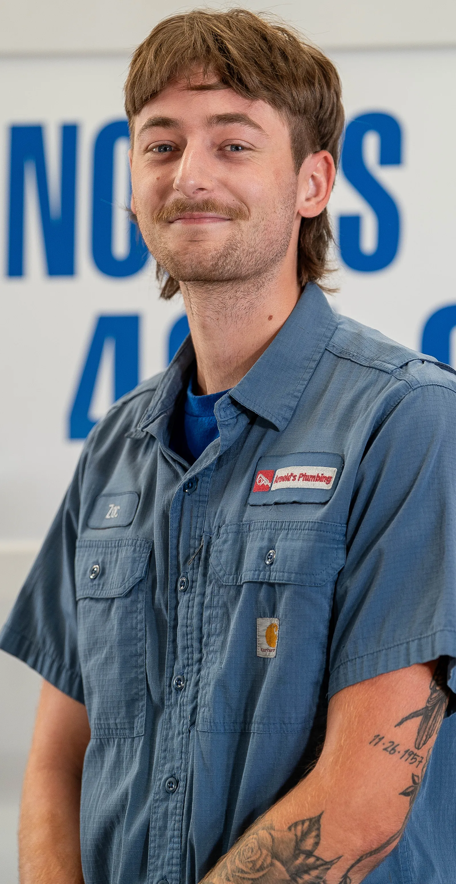 An Arnold's team member photographed in front of the company van