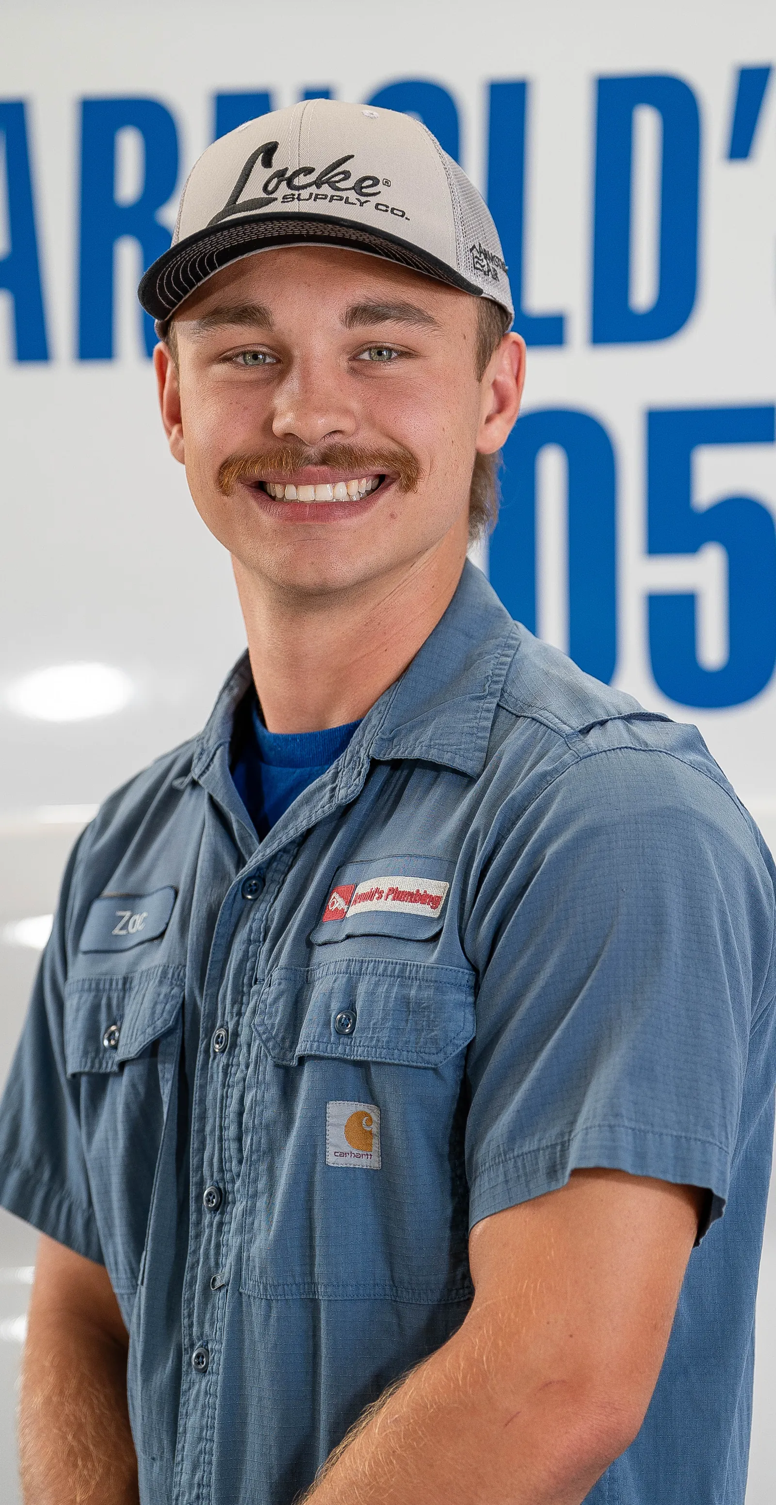 An Arnold's team member photographed in front of the company van