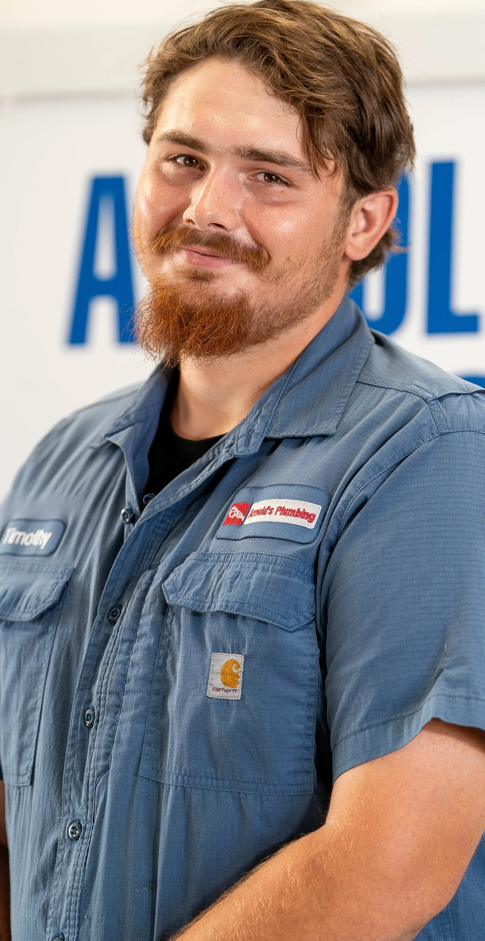An Arnold's team member photographed in front of the company van