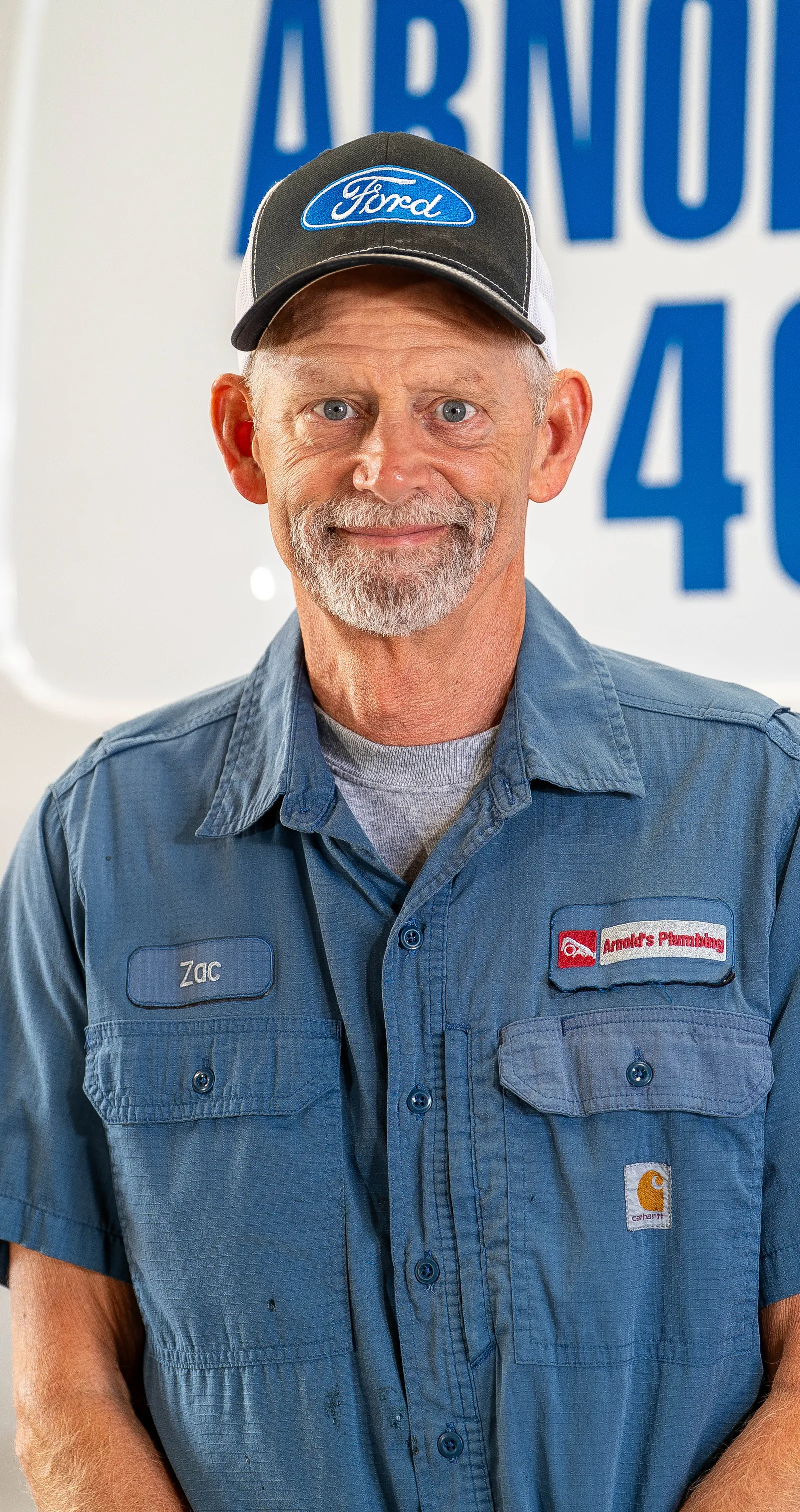 An Arnold's team member photographed in front of the company van